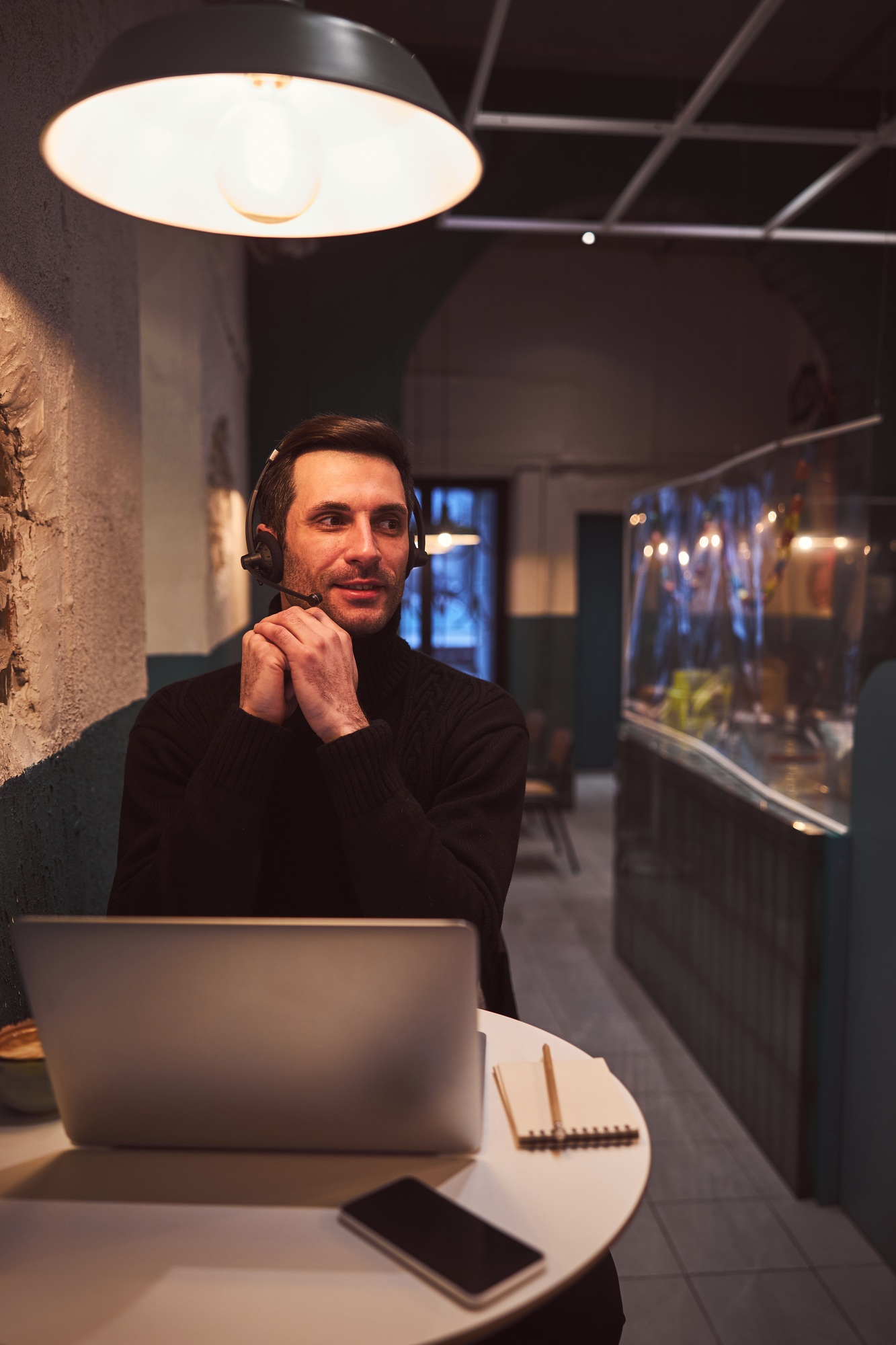 Happy guy making video call on laptop in cafe